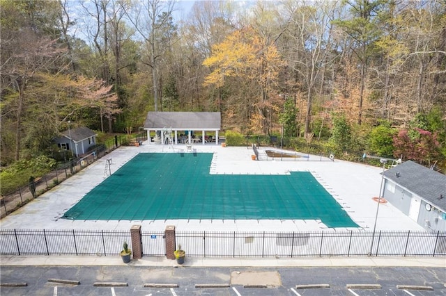 community pool featuring a patio area and fence