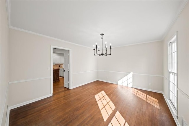 unfurnished dining area with crown molding, dark wood-style flooring, baseboards, and a notable chandelier