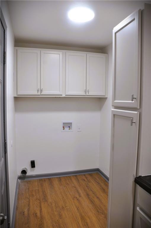 136 Rosewood Dr, Dallas, GA 30132 - laundry room featuring washer hookup, cabinet space, and wood finished floors