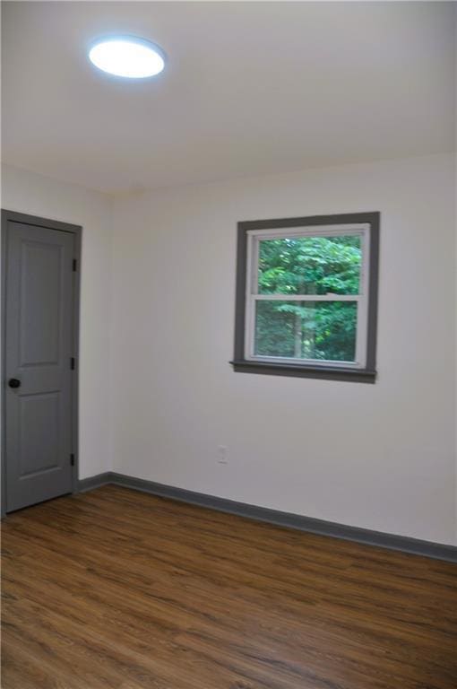 136 Rosewood Dr, Dallas, GA 30132 - empty room featuring dark wood-style flooring and baseboards