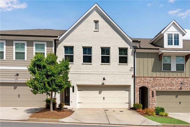 355 Niles Ct Unit 2, Marietta, GA 30060 - townhome / multi-family property featuring board and batten siding, brick siding, an attached garage, and concrete driveway