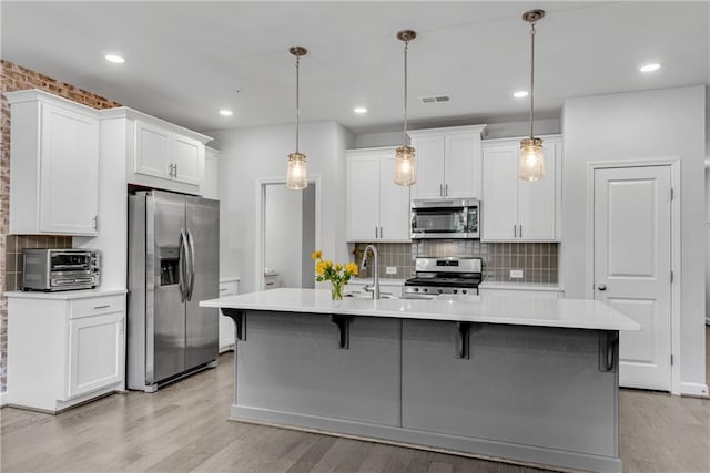 355 Niles Ct Unit 2, Marietta, GA 30060 - kitchen with a toaster, appliances with stainless steel finishes, decorative backsplash, and light countertops
