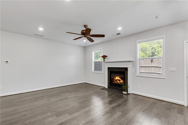 355 Niles Ct Unit 2, Marietta, GA 30060 - unfurnished living room featuring a fireplace with flush hearth, a ceiling fan, wood finished floors, and visible vents