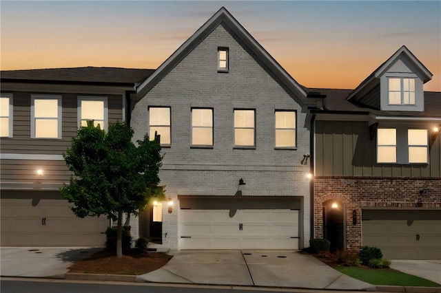 355 Niles Ct Unit 2, Marietta, GA 30060 - view of property with an attached garage, board and batten siding, concrete driveway, and brick siding