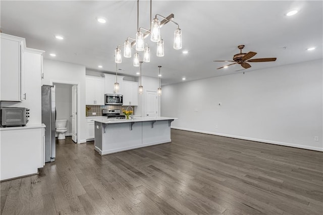 355 Niles Ct Unit 2, Marietta, GA 30060 - kitchen featuring ceiling fan, light countertops, white cabinetry, dark wood finished floors, and stainless steel appliances