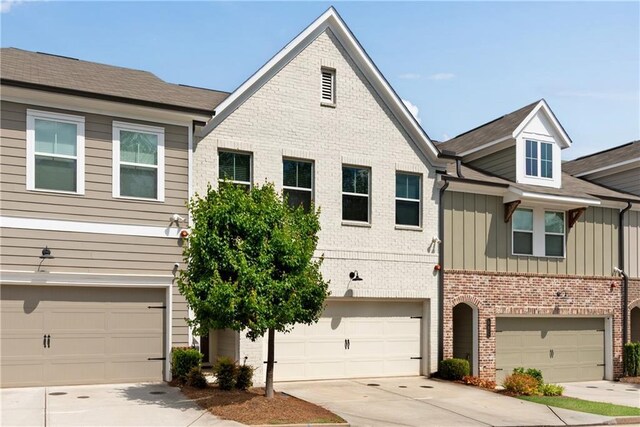 355 Niles Ct Unit 2, Marietta, GA 30060 - view of property with an attached garage, board and batten siding, driveway, and brick siding