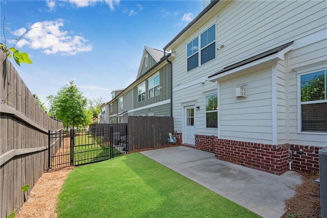 355 Niles Ct Unit 2, Marietta, GA 30060 - back of house featuring a patio, a fenced backyard, board and batten siding, and a lawn