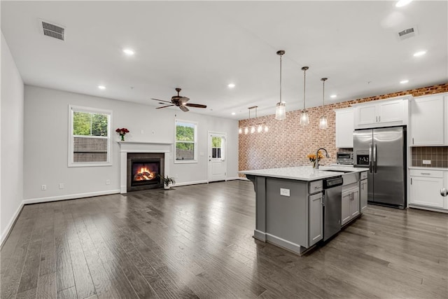 355 Niles Ct Unit 2, Marietta, GA 30060 - kitchen featuring gray cabinetry, stainless steel appliances, open floor plan, and visible vents