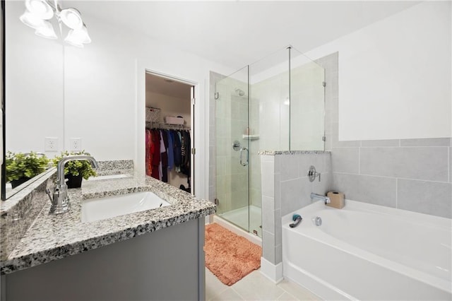 bathroom featuring tile patterned floors, vanity, and independent shower and bath