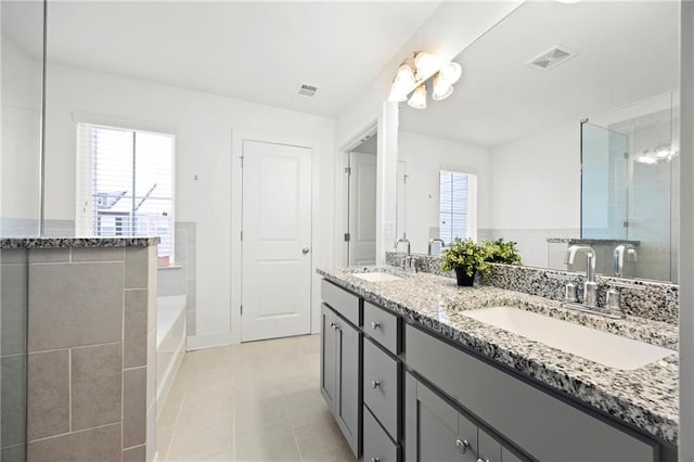 bathroom with tile patterned flooring, vanity, and a shower with shower door