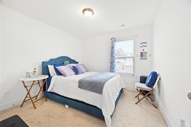 bedroom featuring light colored carpet