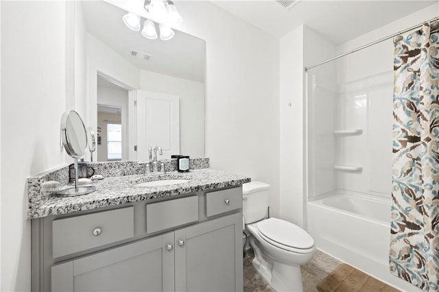 full bathroom with vanity, toilet, and shower / tub combo with curtain