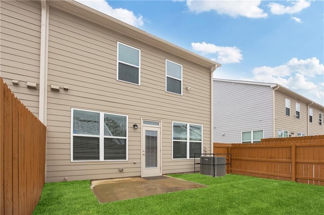 back of house with a yard and a patio