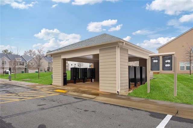 surrounding community featuring mail boxes and a yard