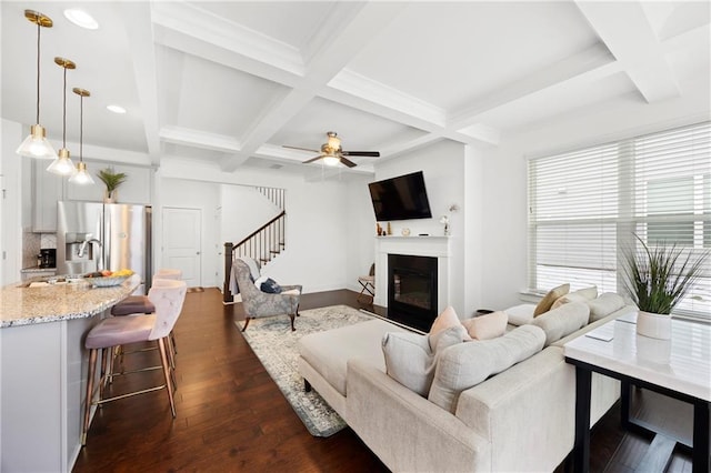 living room featuring beam ceiling, dark hardwood / wood-style flooring, ceiling fan, and coffered ceiling