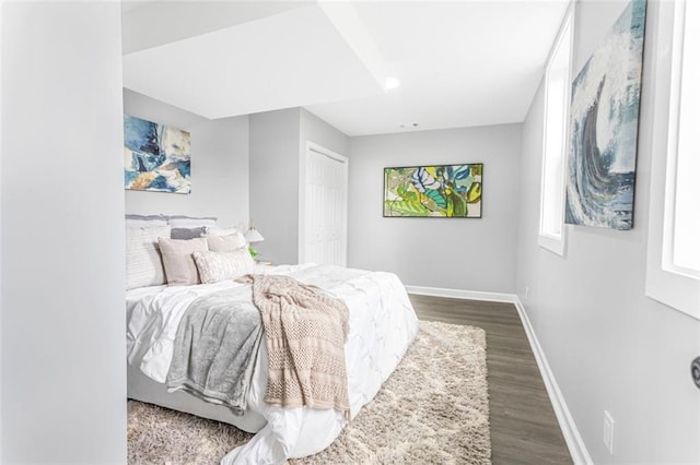 bedroom featuring a closet and dark hardwood / wood-style flooring