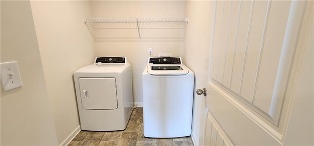 clothes washing area featuring separate washer and dryer and light hardwood / wood-style flooring