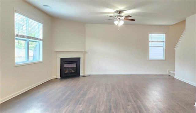 unfurnished living room featuring ceiling fan and hardwood / wood-style flooring