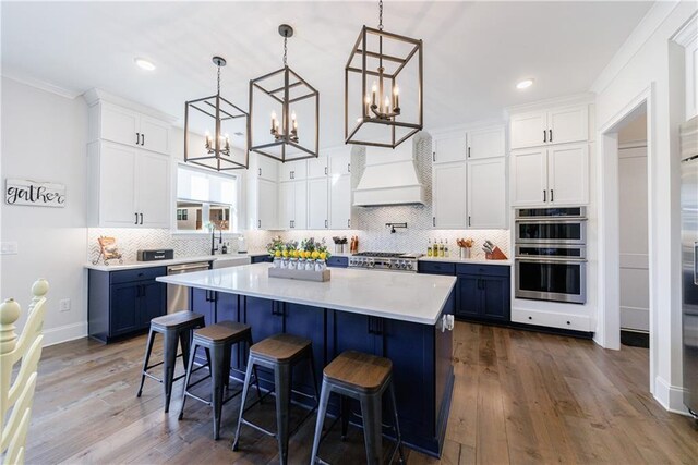 dining room with sink, crown molding, and dark wood-type flooring