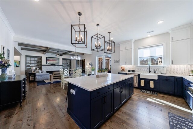 kitchen featuring blue cabinetry, premium range hood, white cabinetry, stainless steel appliances, and dark hardwood / wood-style flooring