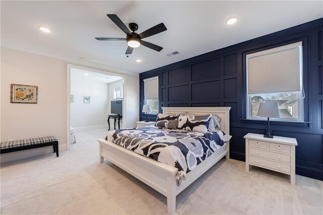 bedroom with ceiling fan and light carpet