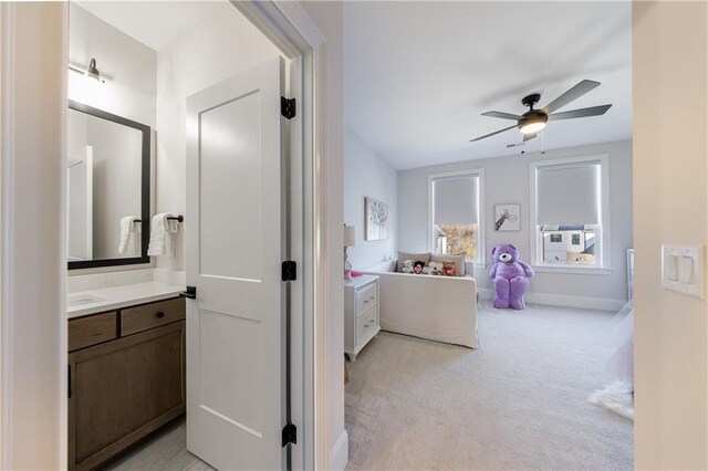 clothes washing area featuring cabinets, washing machine and clothes dryer, sink, and light tile patterned floors