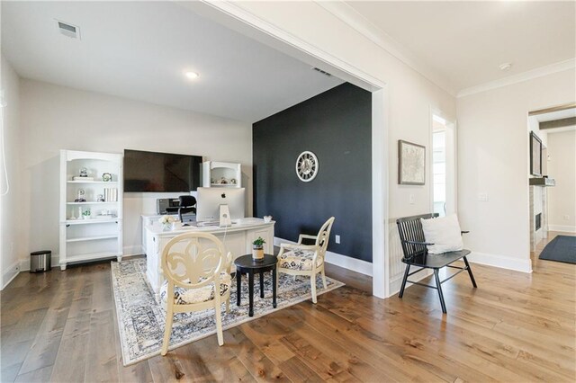 hallway with hardwood / wood-style flooring and crown molding