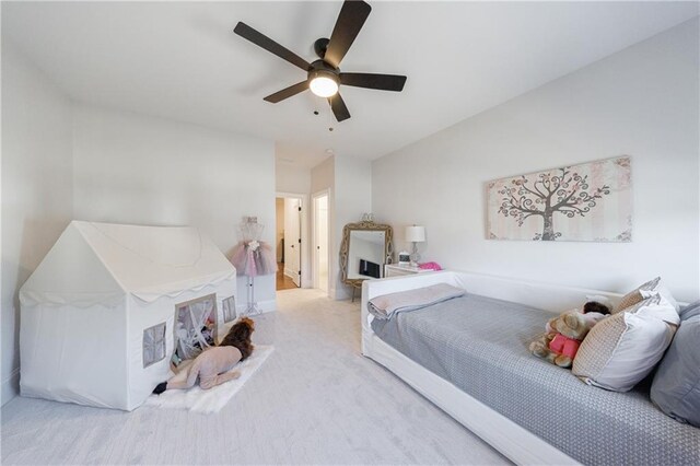 bedroom featuring ceiling fan and light carpet