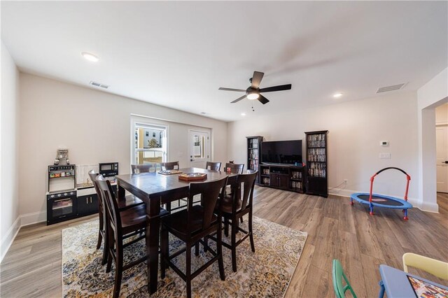 dining room with hardwood / wood-style flooring and ceiling fan