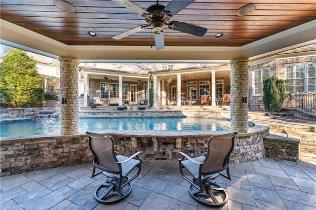 view of swimming pool featuring an infinity pool, ceiling fan, and a patio area