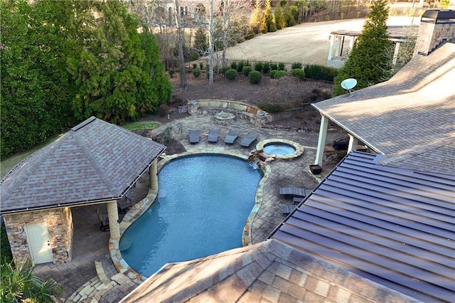 outdoor pool with an in ground hot tub and a patio