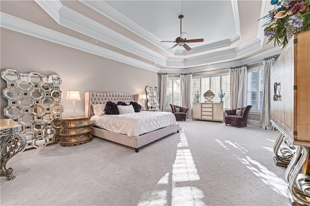 carpeted bedroom featuring ornamental molding, a raised ceiling, and ceiling fan