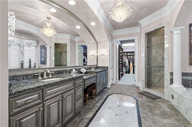 bathroom featuring ornate columns, a sink, and crown molding