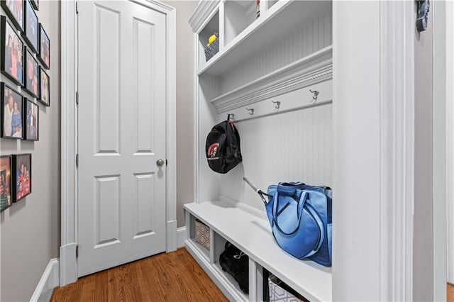 mudroom featuring wood finished floors and baseboards