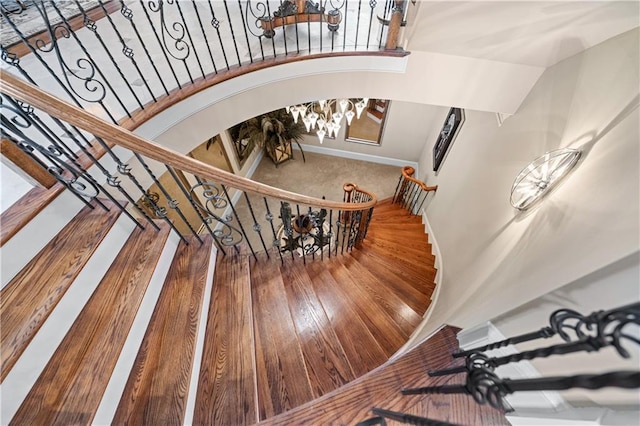 staircase featuring arched walkways and baseboards