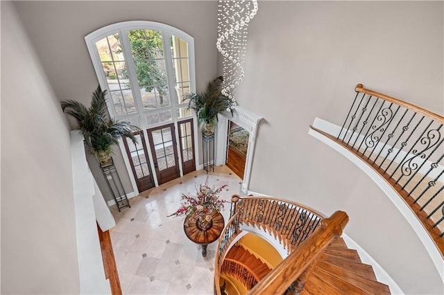 foyer entrance with stairs and baseboards