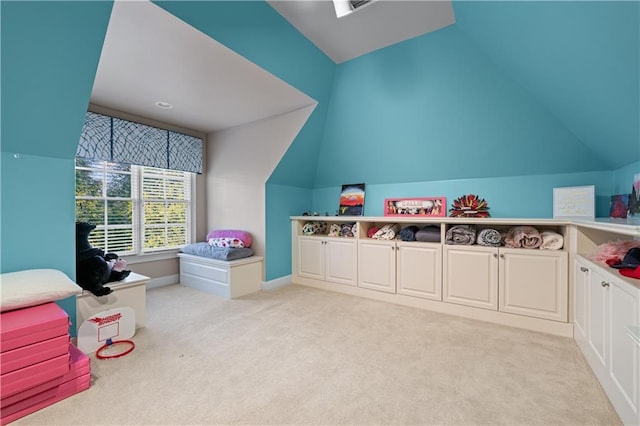 recreation room featuring light carpet, baseboards, and lofted ceiling