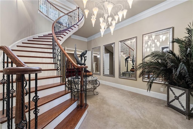 staircase with baseboards, ornamental molding, a chandelier, and carpet flooring