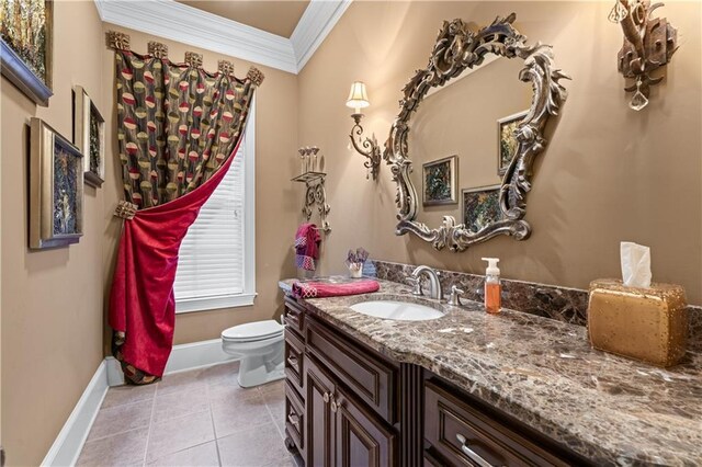 bathroom featuring baseboards, toilet, tile patterned floors, crown molding, and vanity