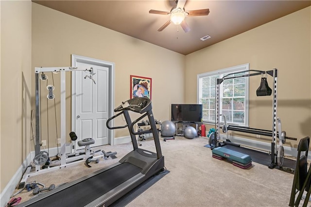 exercise area featuring baseboards, ceiling fan, visible vents, and carpet flooring