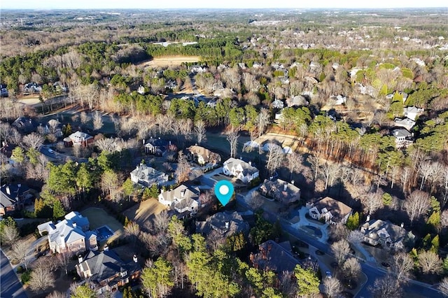 bird's eye view with a wooded view