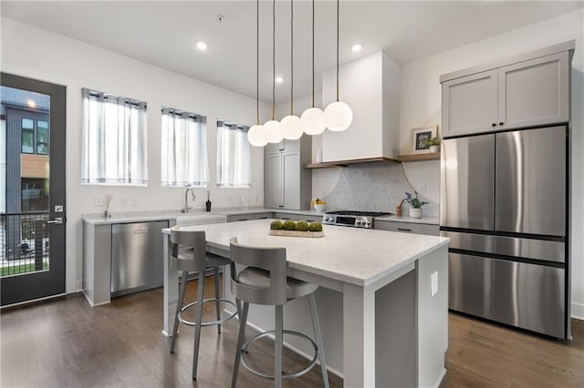 2347 Hosea L Williams Dr NE Unit 11, Atlanta, GA 30317 - kitchen featuring stainless steel appliances, a kitchen island, dark wood-type flooring, a breakfast bar, and decorative backsplash