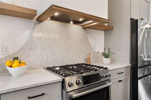 2347 Hosea L Williams Dr NE Unit 11, Atlanta, GA 30317 - kitchen with appliances with stainless steel finishes, range hood, tasteful backsplash, and white cabinetry