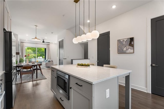 2347 Hosea L Williams Dr NE Unit 11, Atlanta, GA 30317 - kitchen with stainless steel microwave, freestanding refrigerator, dark wood-style floors, open floor plan, and a center island