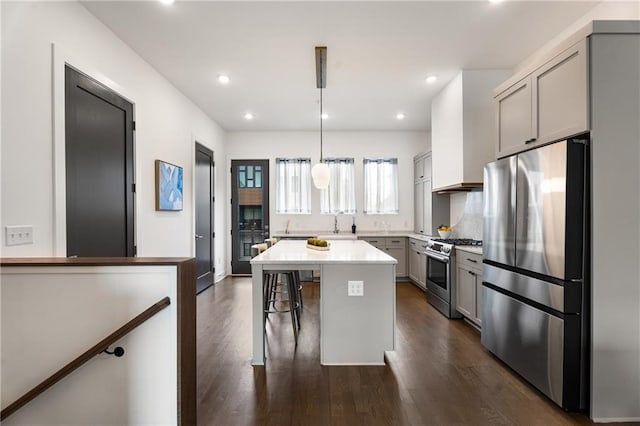 2347 Hosea L Williams Dr NE Unit 11, Atlanta, GA 30317 - kitchen featuring appliances with stainless steel finishes, gray cabinets, dark wood-style flooring, a kitchen bar, and recessed lighting