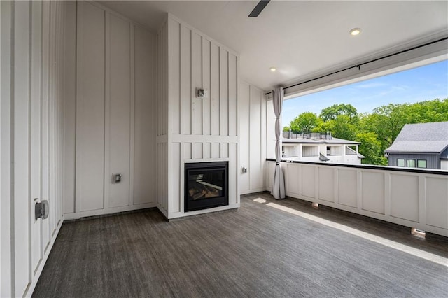 2347 Hosea L Williams Dr NE Unit 11, Atlanta, GA 30317 - unfurnished living room with a decorative wall, a fireplace, wood finished floors, and a ceiling fan