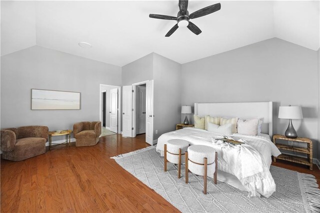 bedroom with wood finished floors, a ceiling fan, and vaulted ceiling