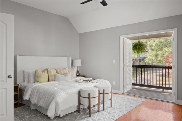 bedroom featuring ceiling fan, access to outside, wood finished floors, baseboards, and lofted ceiling