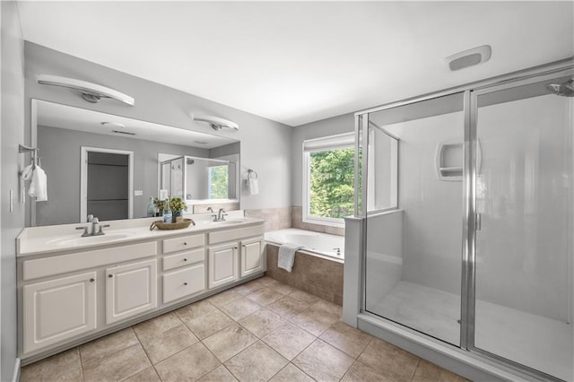 full bathroom with a garden tub, double vanity, a sink, and a shower stall