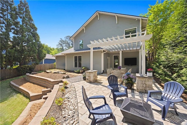 back of house with fence, a fire pit, a patio area, and a pergola